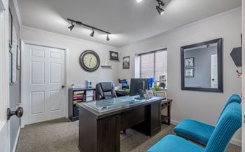 A room with a desk and a blue chair